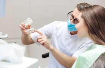 Dentist Shpwing Patient a Set of DenturesMarietta GA