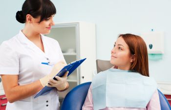 a doctor and a patient in the dentist's chair