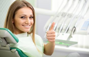 Woman in Dentist Chair Giving a Thumbs Up Atlanta GA 