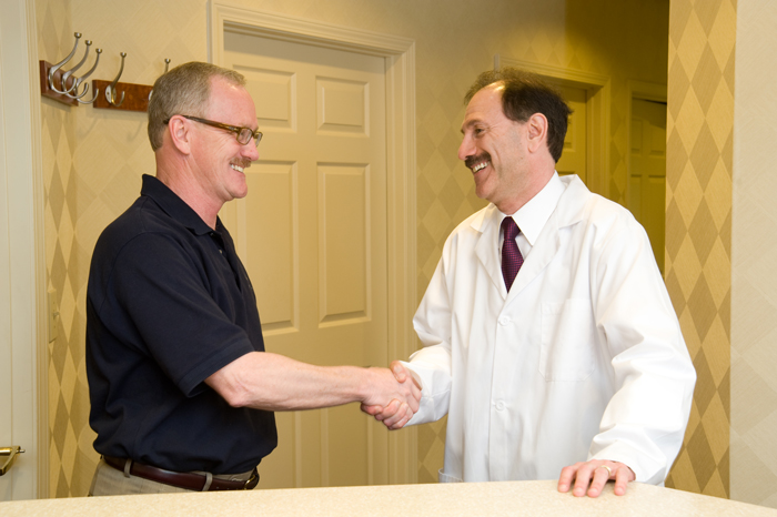 Dr Suway shaking hands with patient