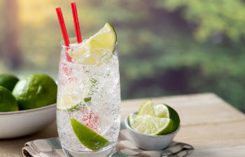 Glass of sparkling cold water with lime